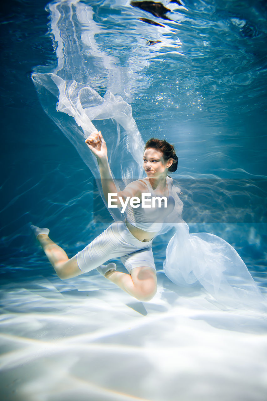 high angle view of woman swimming in pool