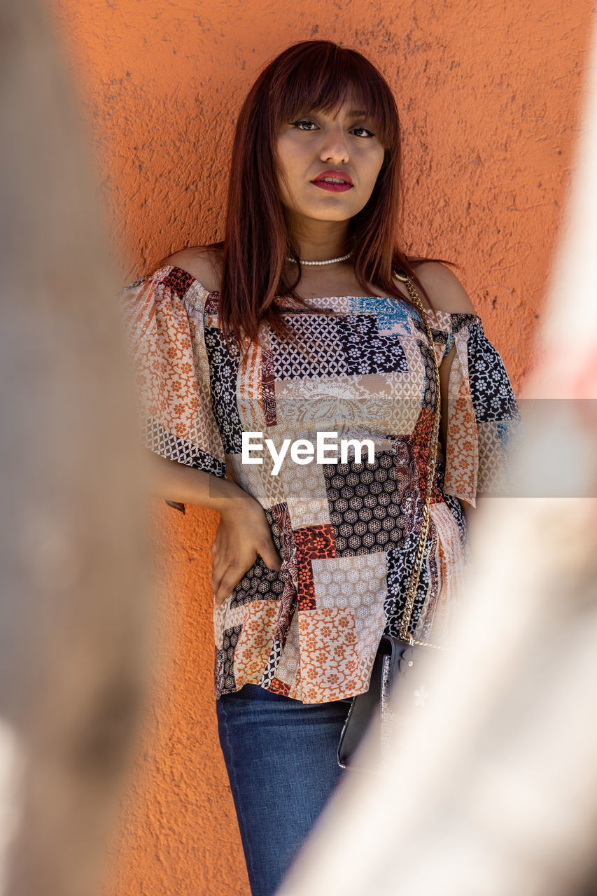 Girl in casual clothes posing on the city streets on a sunny day