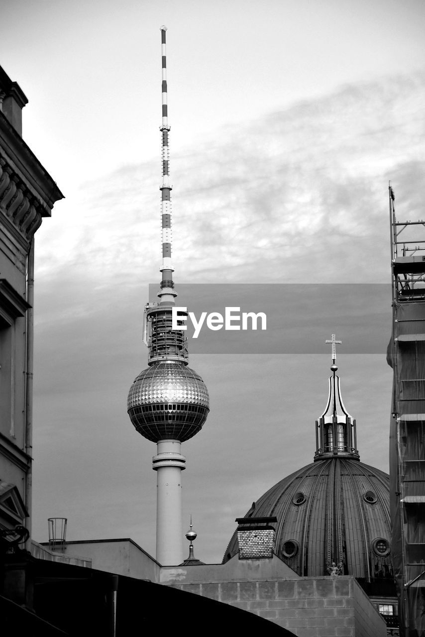 TOWER AMIDST BUILDINGS AGAINST SKY