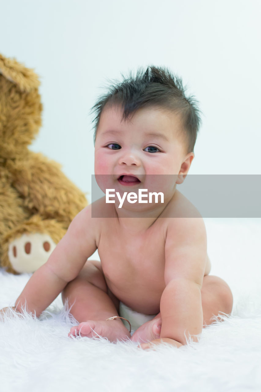 Portrait of cute baby on bed