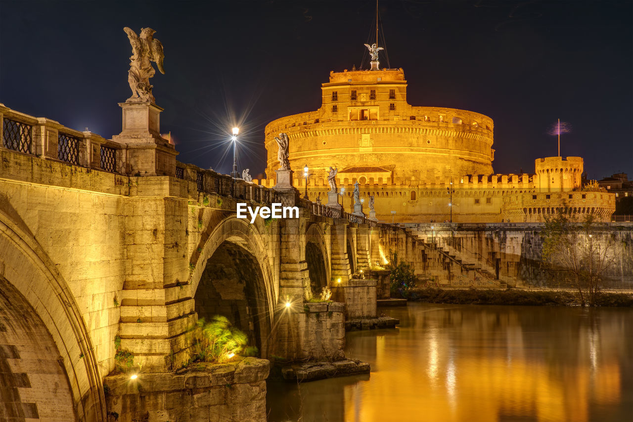 The famous castel sant angelo and the sant angelo bridge in rome, italy, at night
