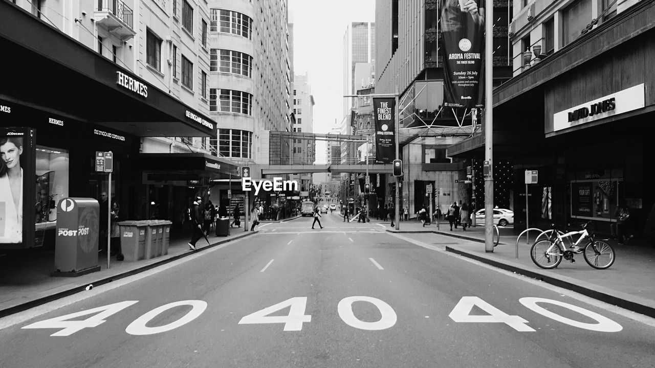 High angle view of numbers on street amidst buildings in city