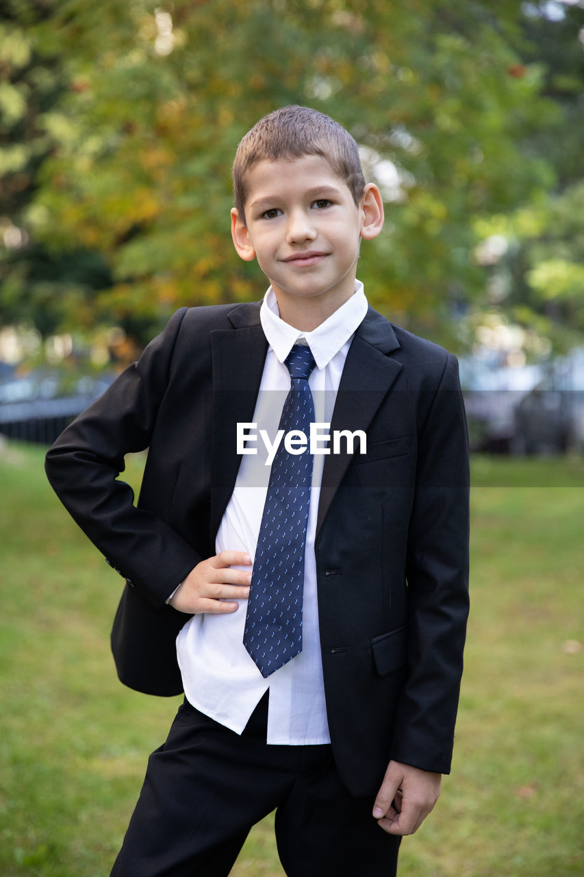 PORTRAIT OF BOY STANDING OUTDOORS