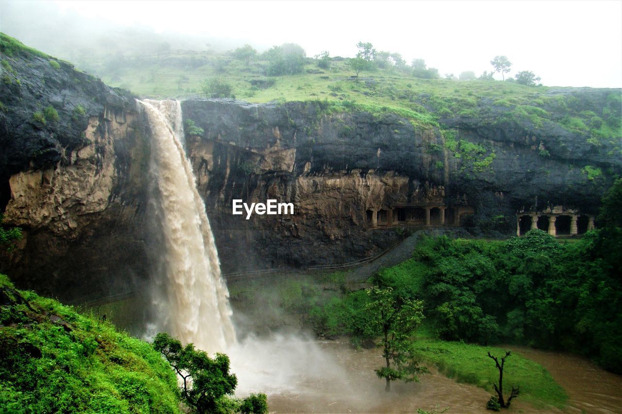 SCENIC VIEW OF WATERFALL ON MOUNTAIN