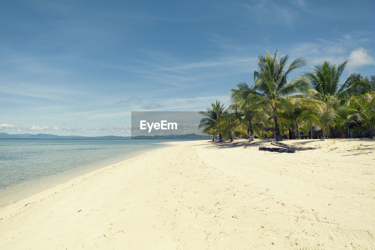 Scenic view of beach against sky on sunny day