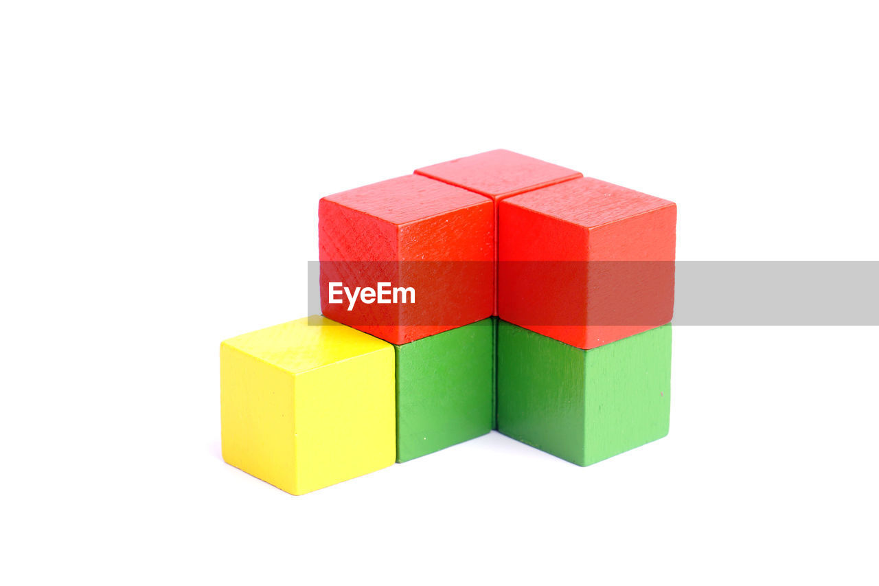 Multi colored toy blocks against white background