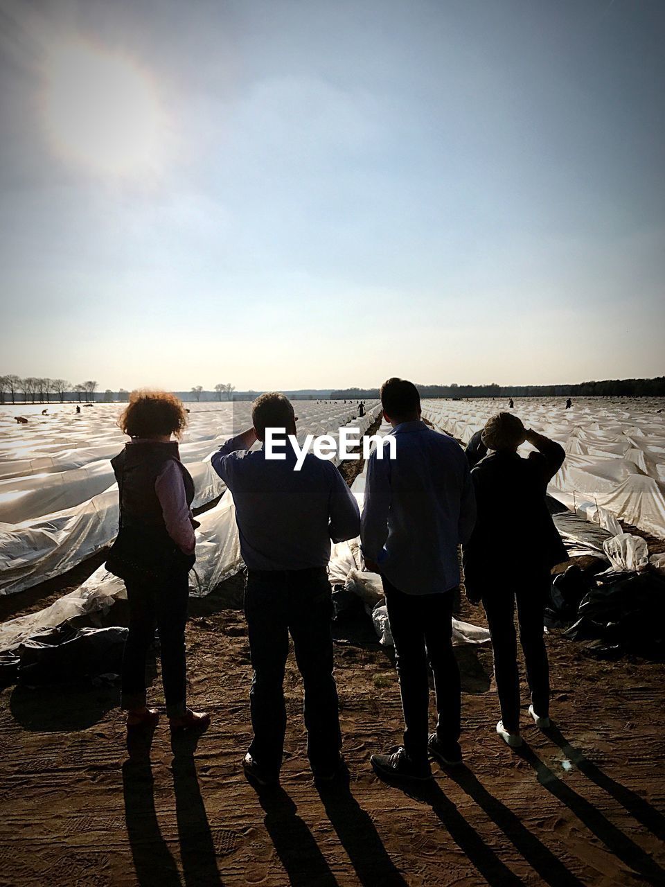 REAR VIEW OF TWO PEOPLE ON BEACH