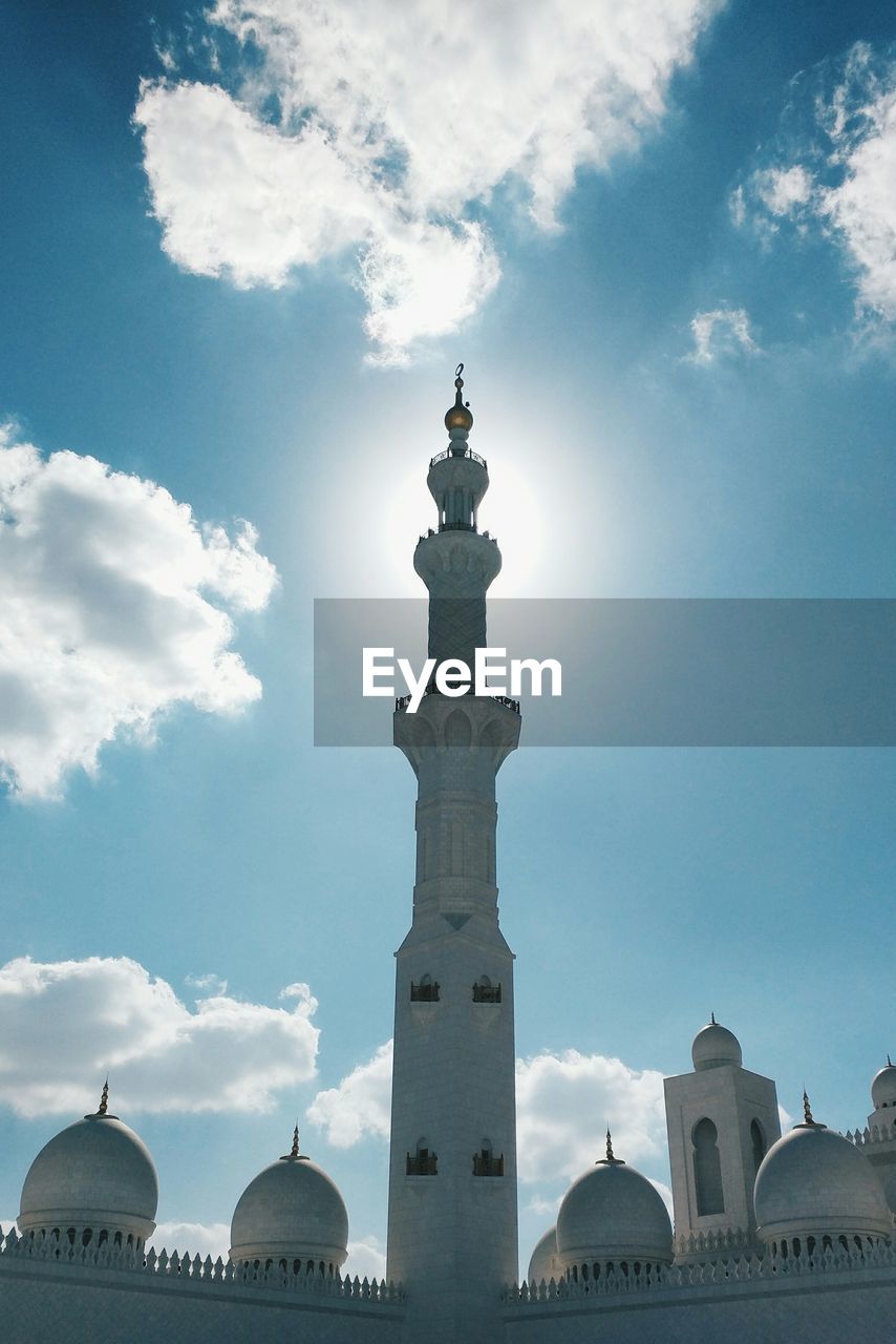 Low angle view of minaret at sheikh zayed mosque on sunny day