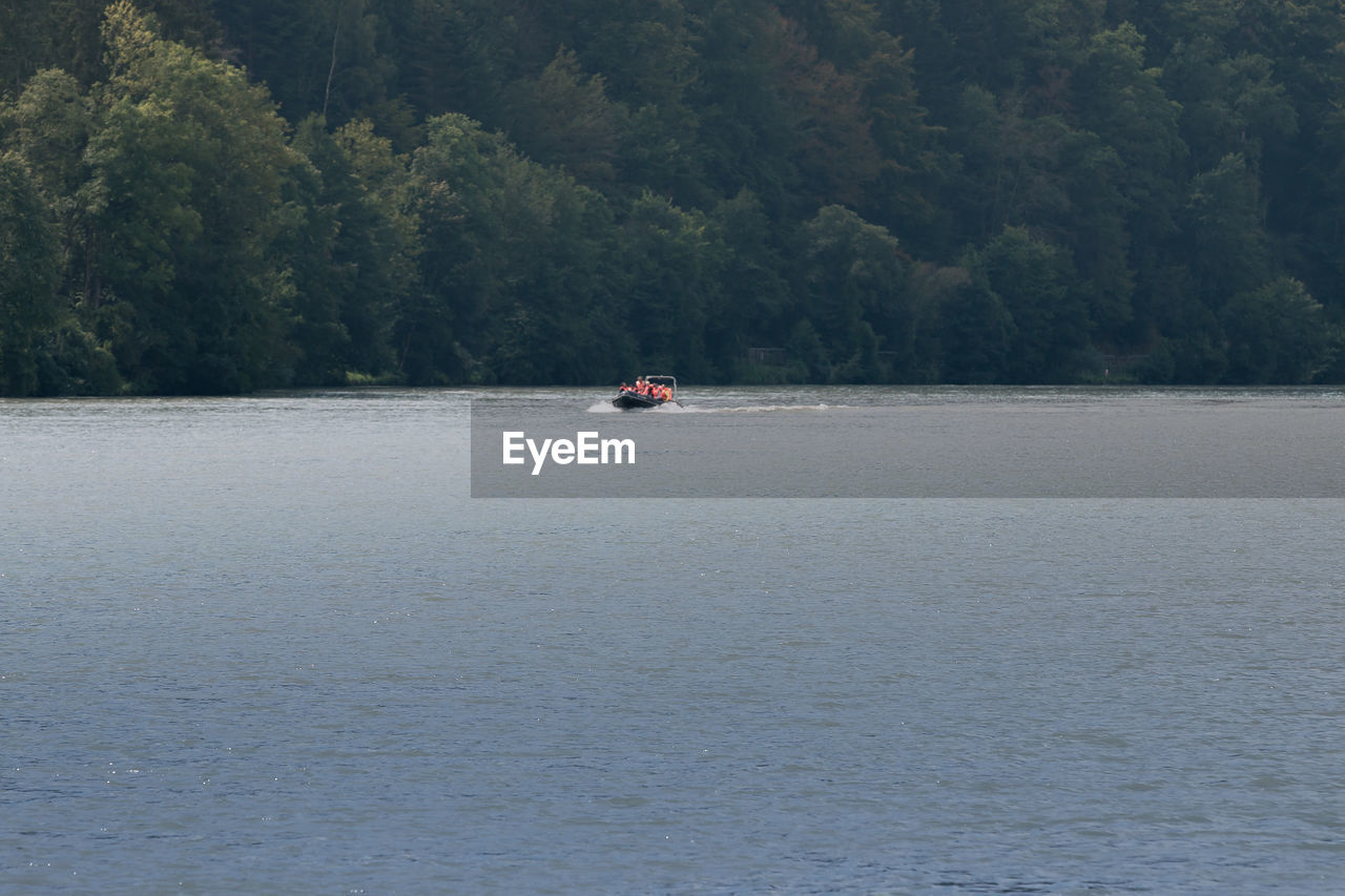 MAN ON BOAT AGAINST SEA