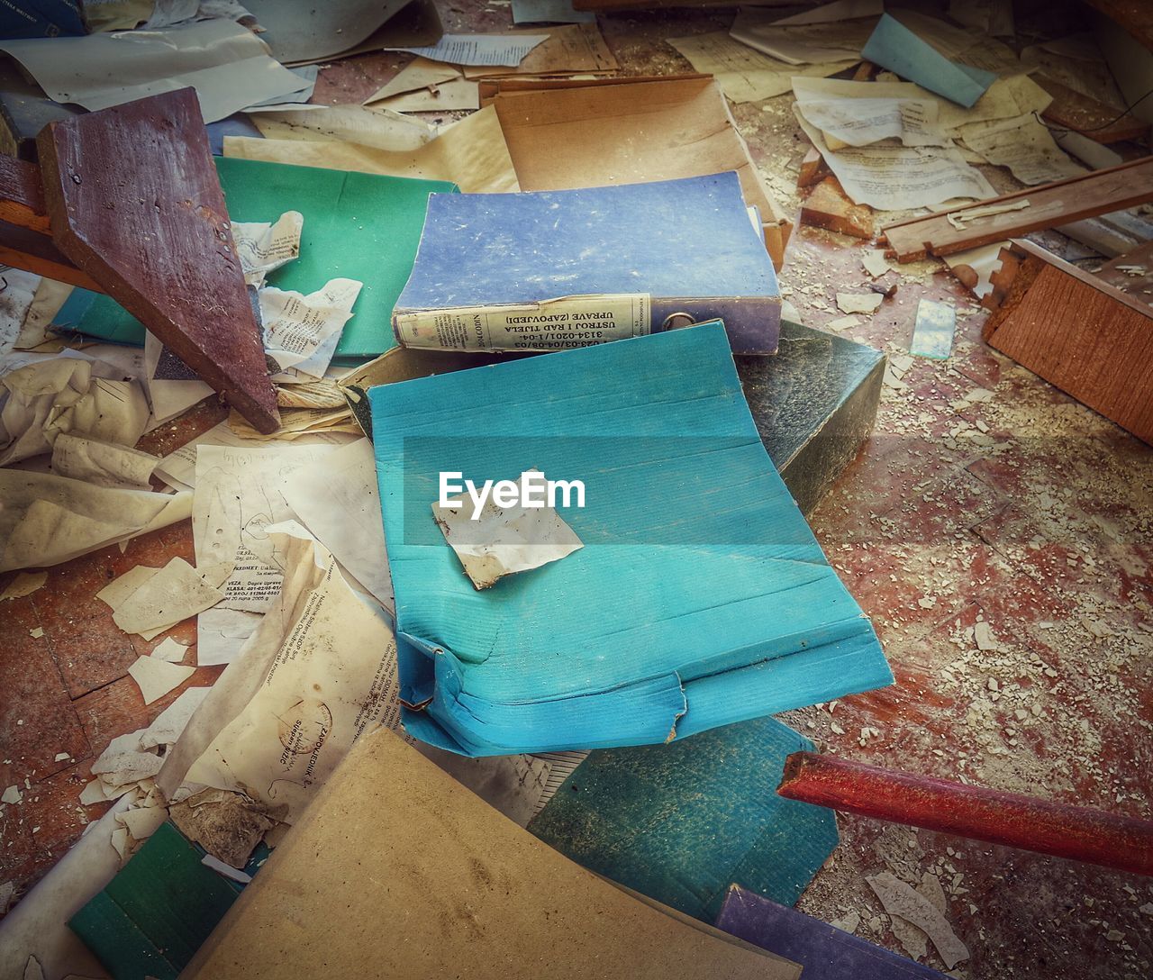 High angle view of old books on messy floor