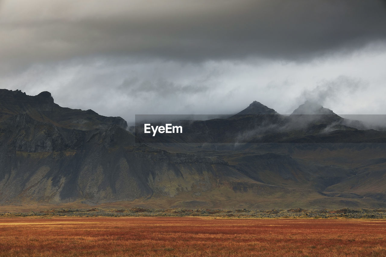 Scenic view of landscape and mountains against sky