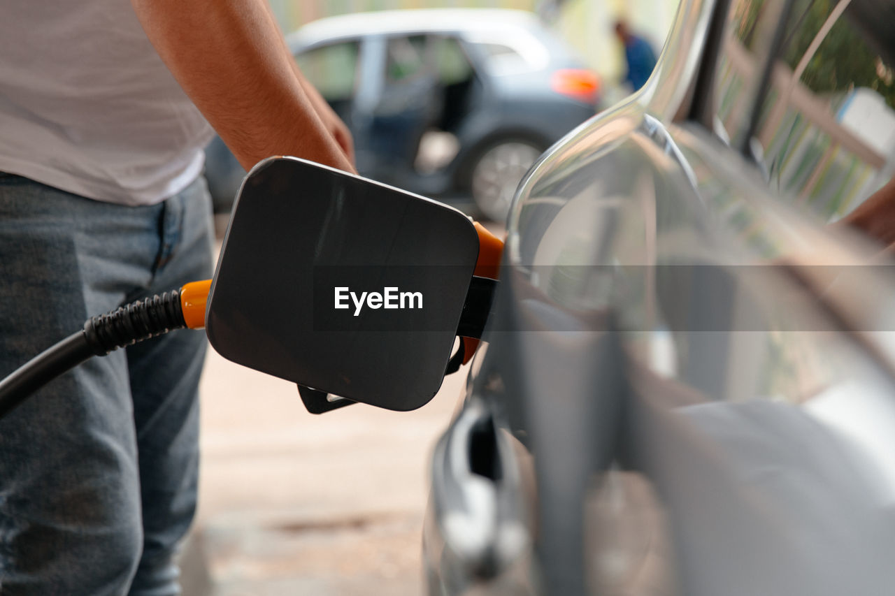 Refuel cars at the fuel pump. the driver hands, 