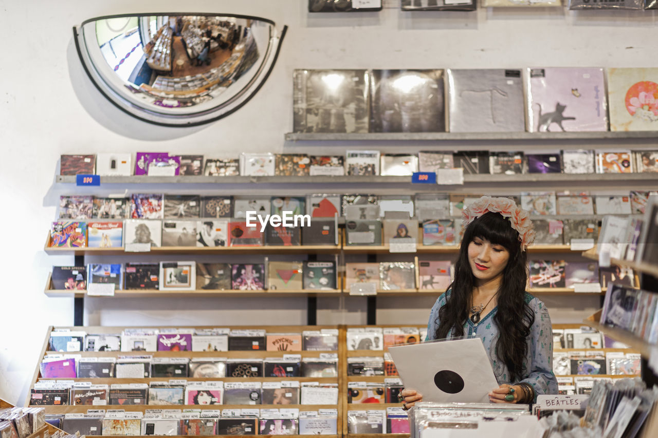Young woman browsing albums in a record store
