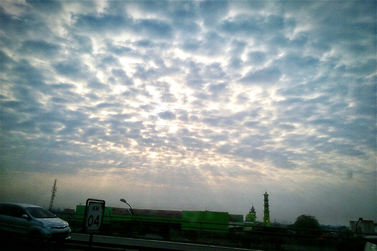 VIEW OF ROAD AGAINST CLOUDY SKY AT DUSK