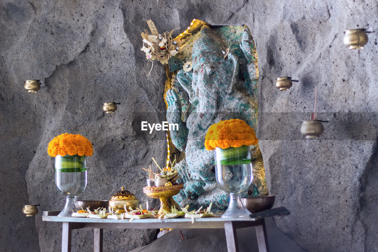 Close-up of ganesha statue in temple against wall