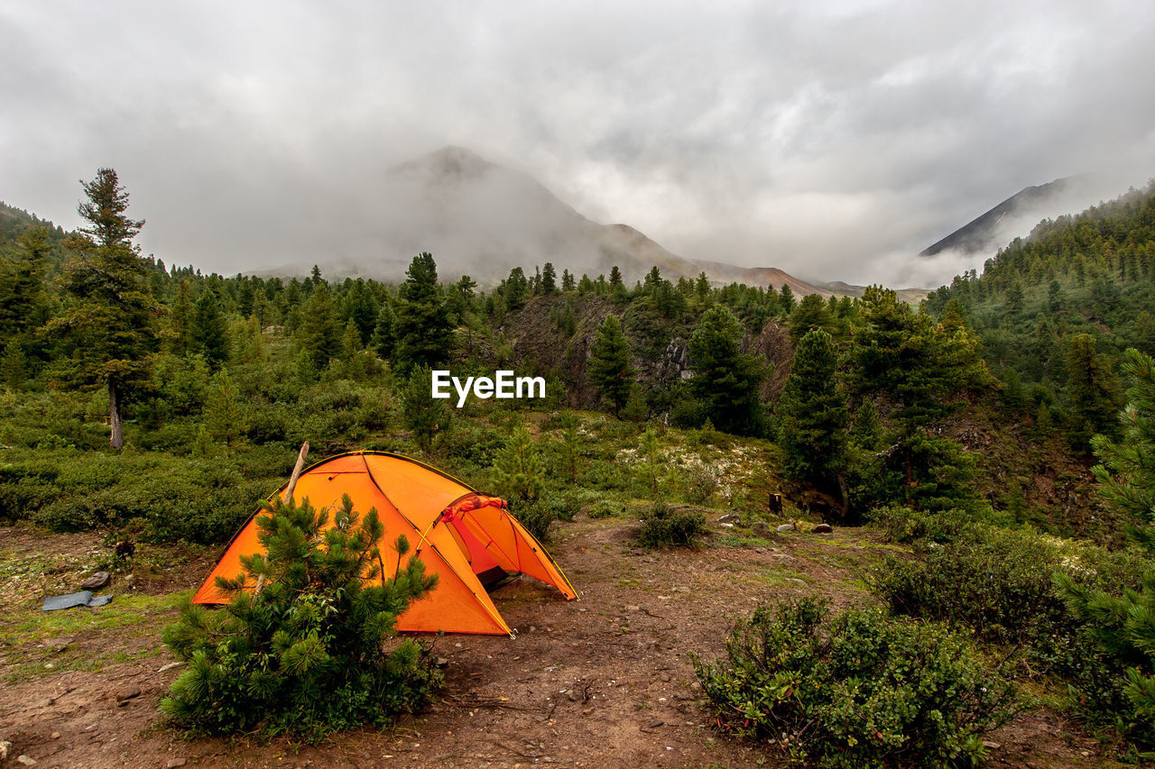 TENT ON MOUNTAIN AGAINST SKY