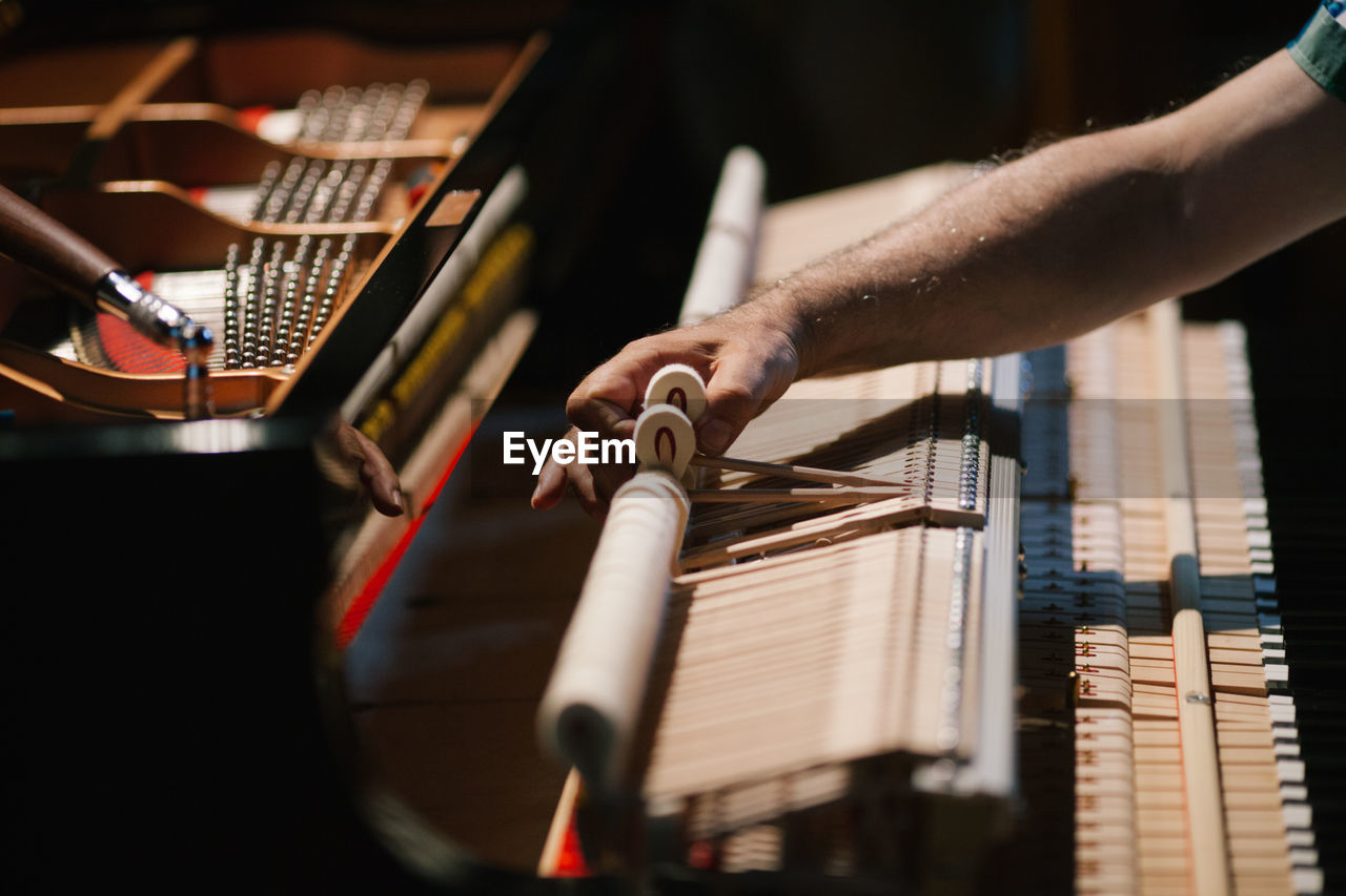 Cropped image of hand working on piano