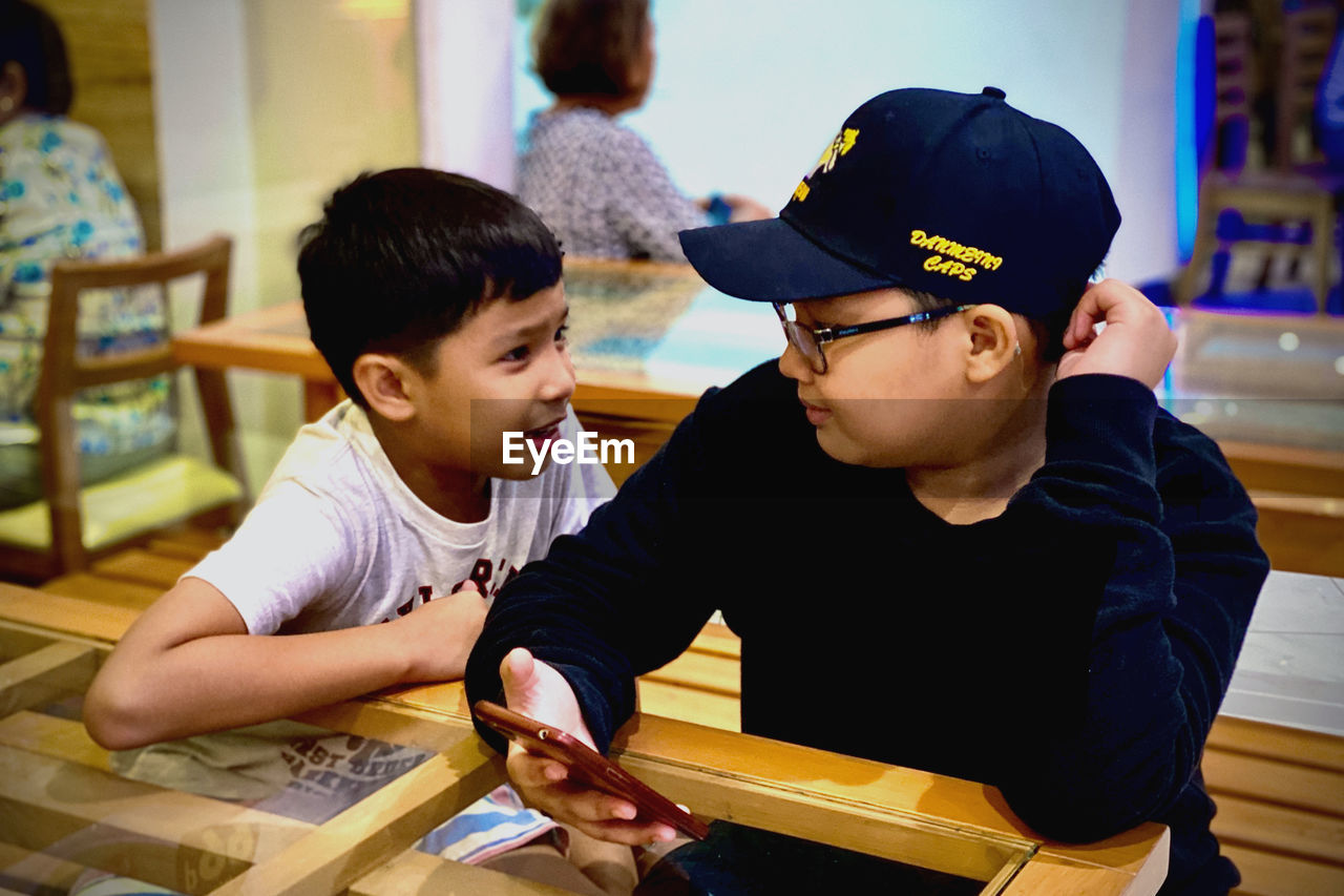 Smiling boy talking to brother