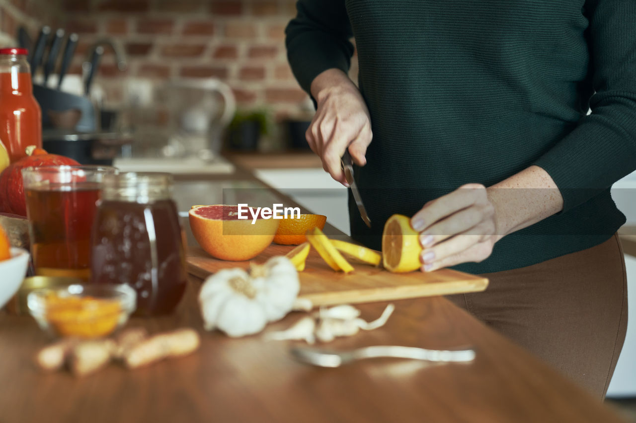 Midsection of woman preparing food on table