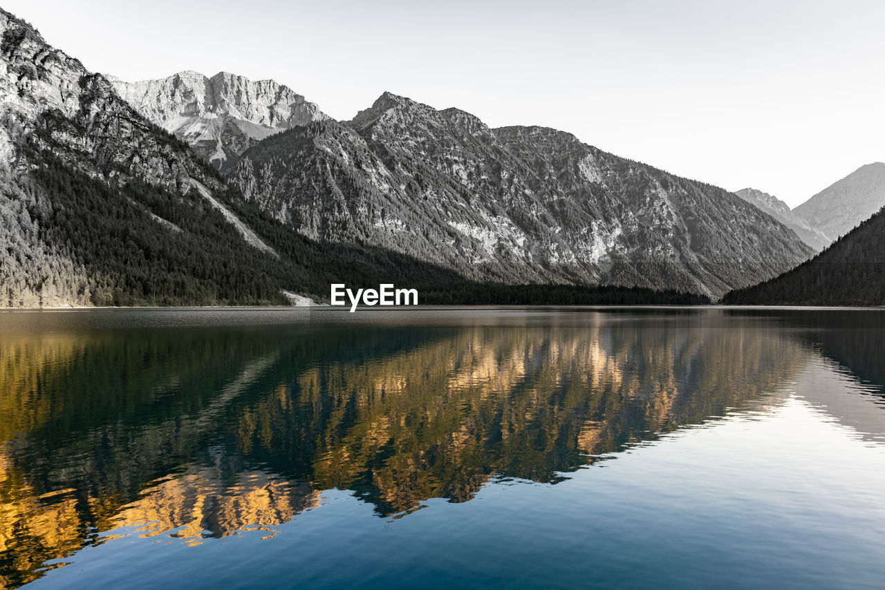 Scenic view of lake and mountains against sky