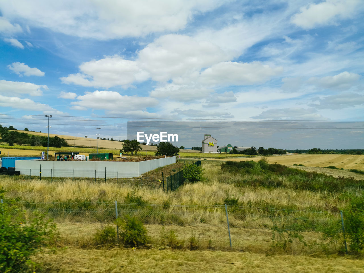 BUILT STRUCTURE ON FIELD AGAINST SKY