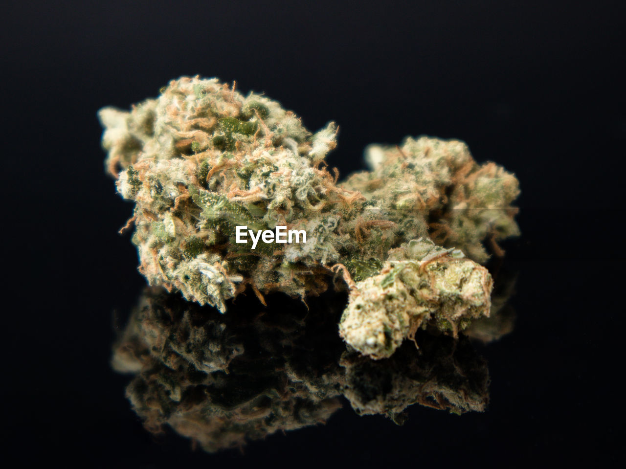 Close-up of marijuana over black background