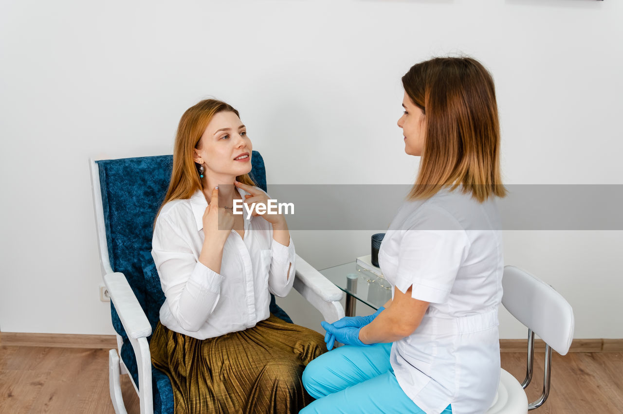 Consultation in cosmetology clinic. female doctor talking with patient.