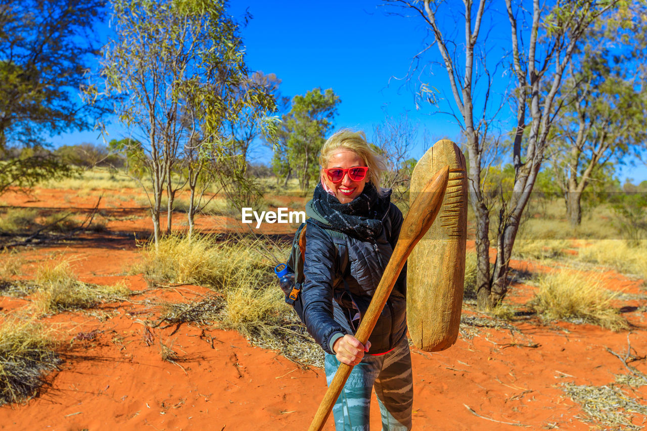 Portrait of smiling woman standing on land