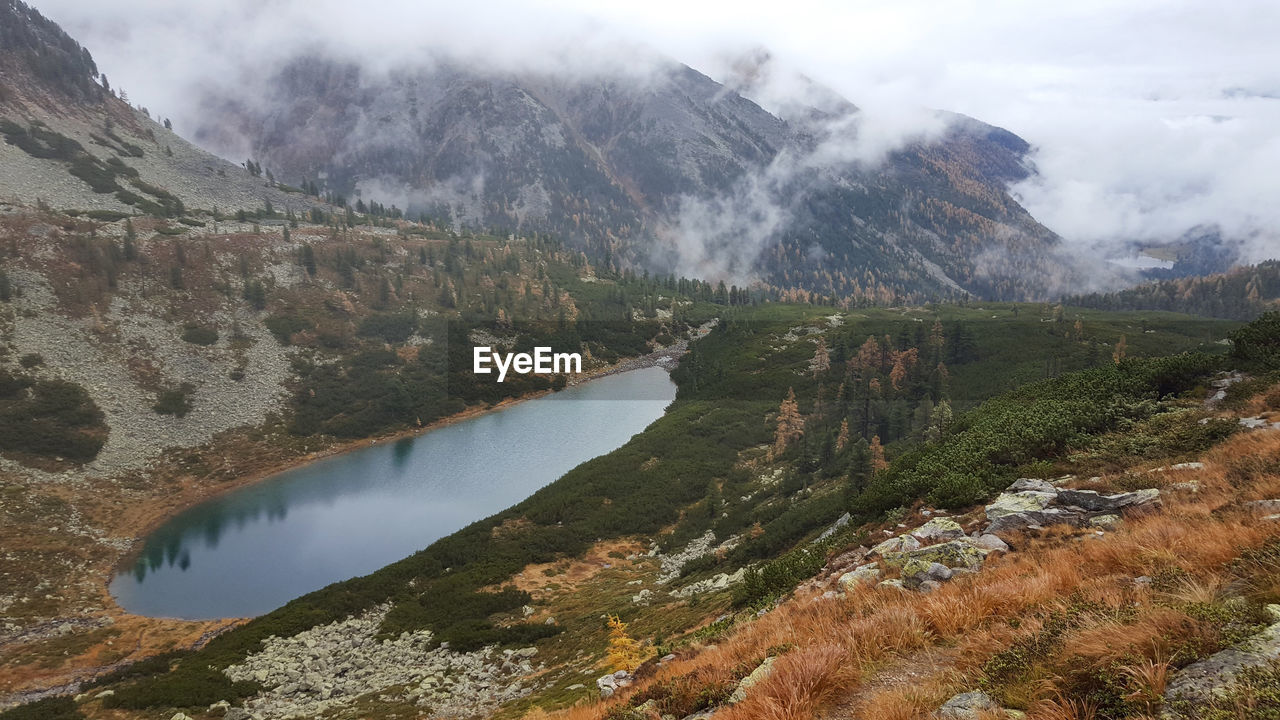 Scenic view of lake and mountains against sky