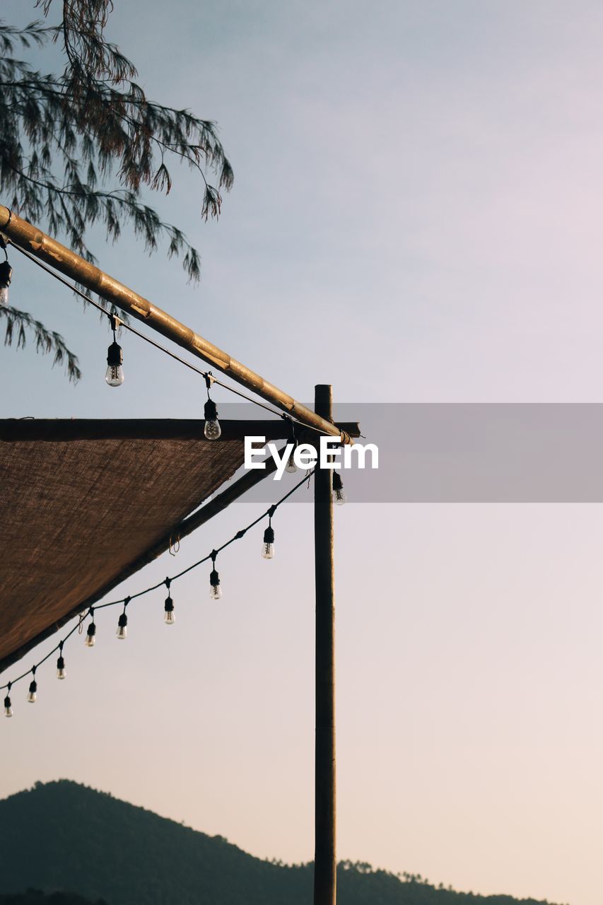 LOW ANGLE VIEW OF ROOF HANGING AGAINST SKY