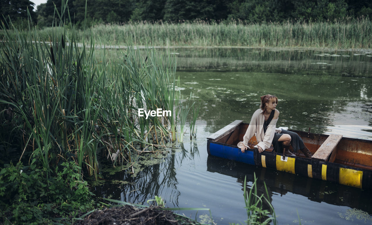 A woman in a boat floats on the river