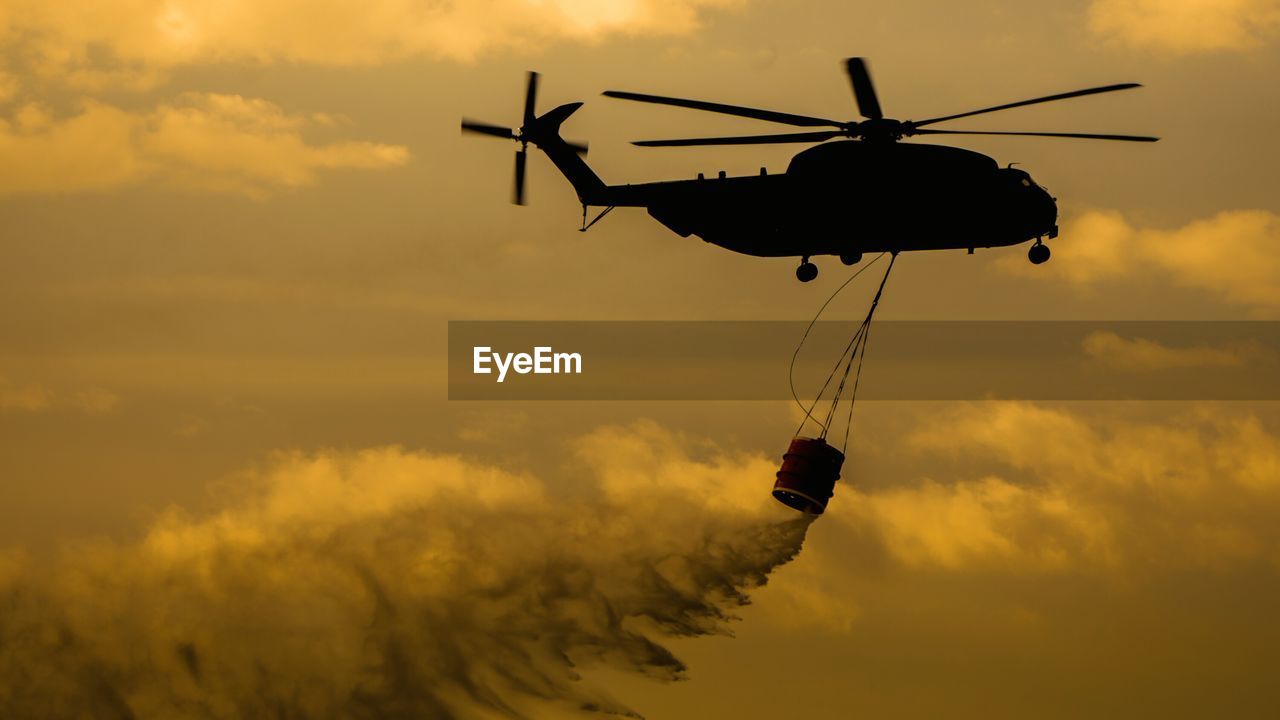 LOW ANGLE VIEW OF SILHOUETTE HELICOPTER AGAINST SKY