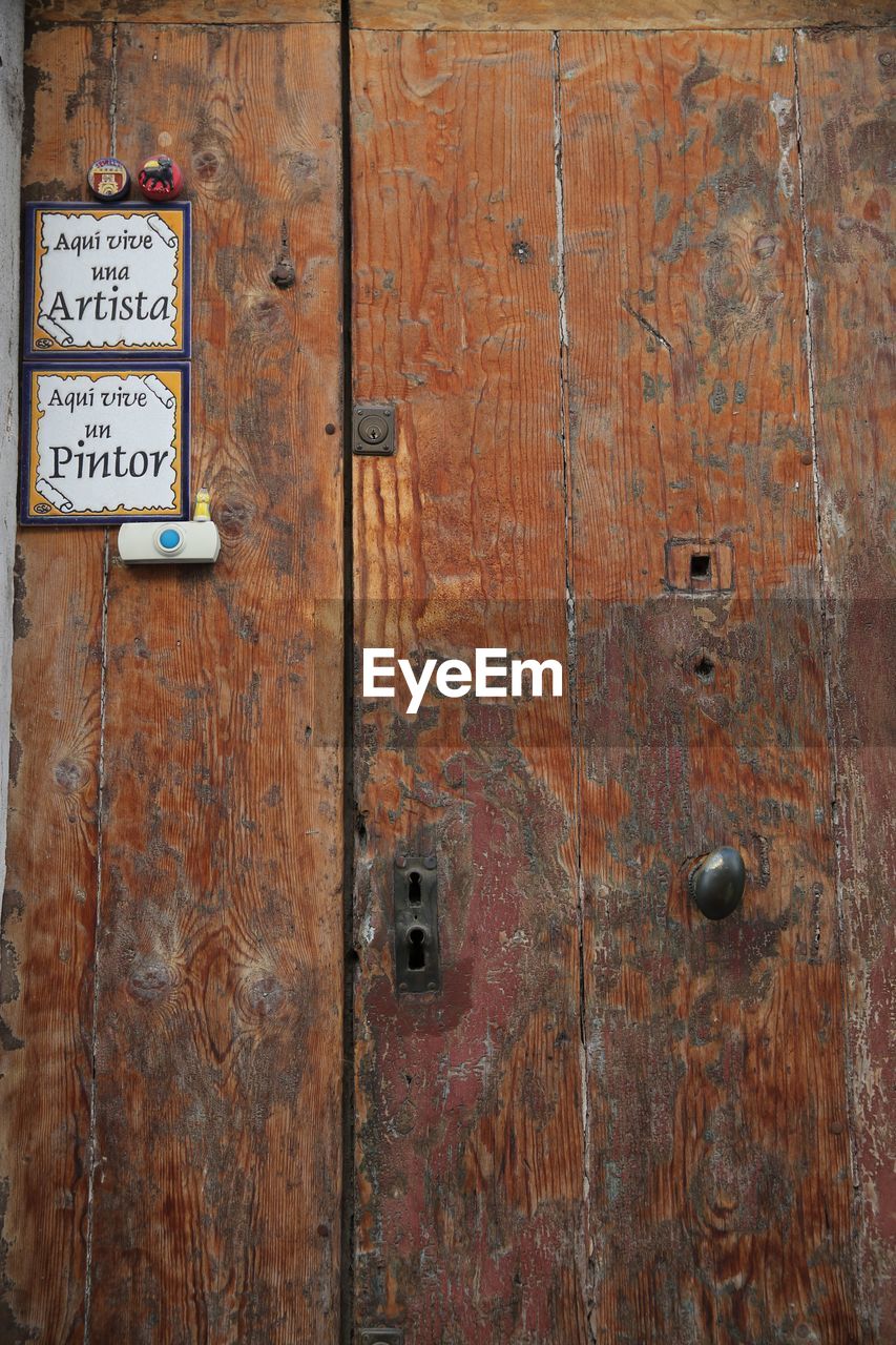 FULL FRAME SHOT OF OLD DOOR WITH TEXT