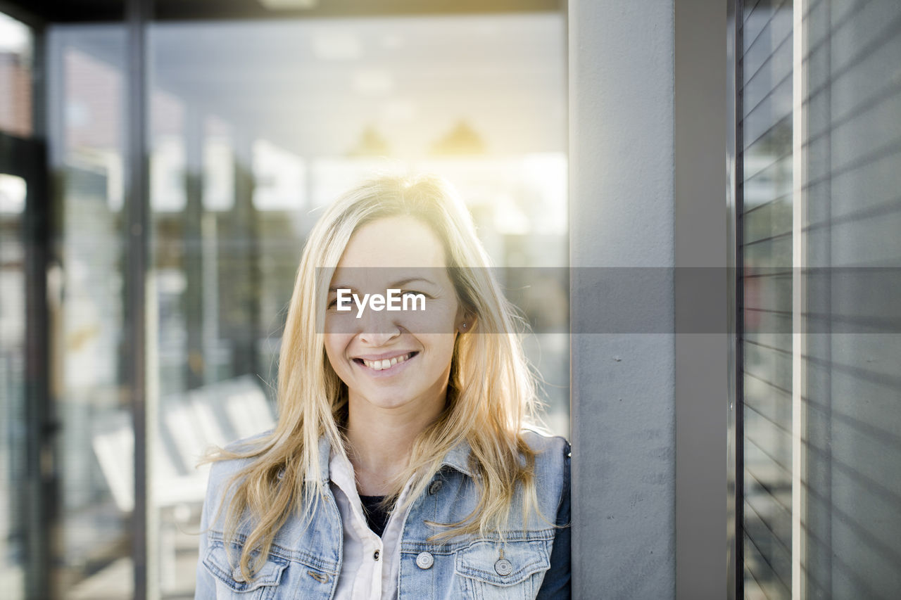 Portrait of smiling woman with blond hair