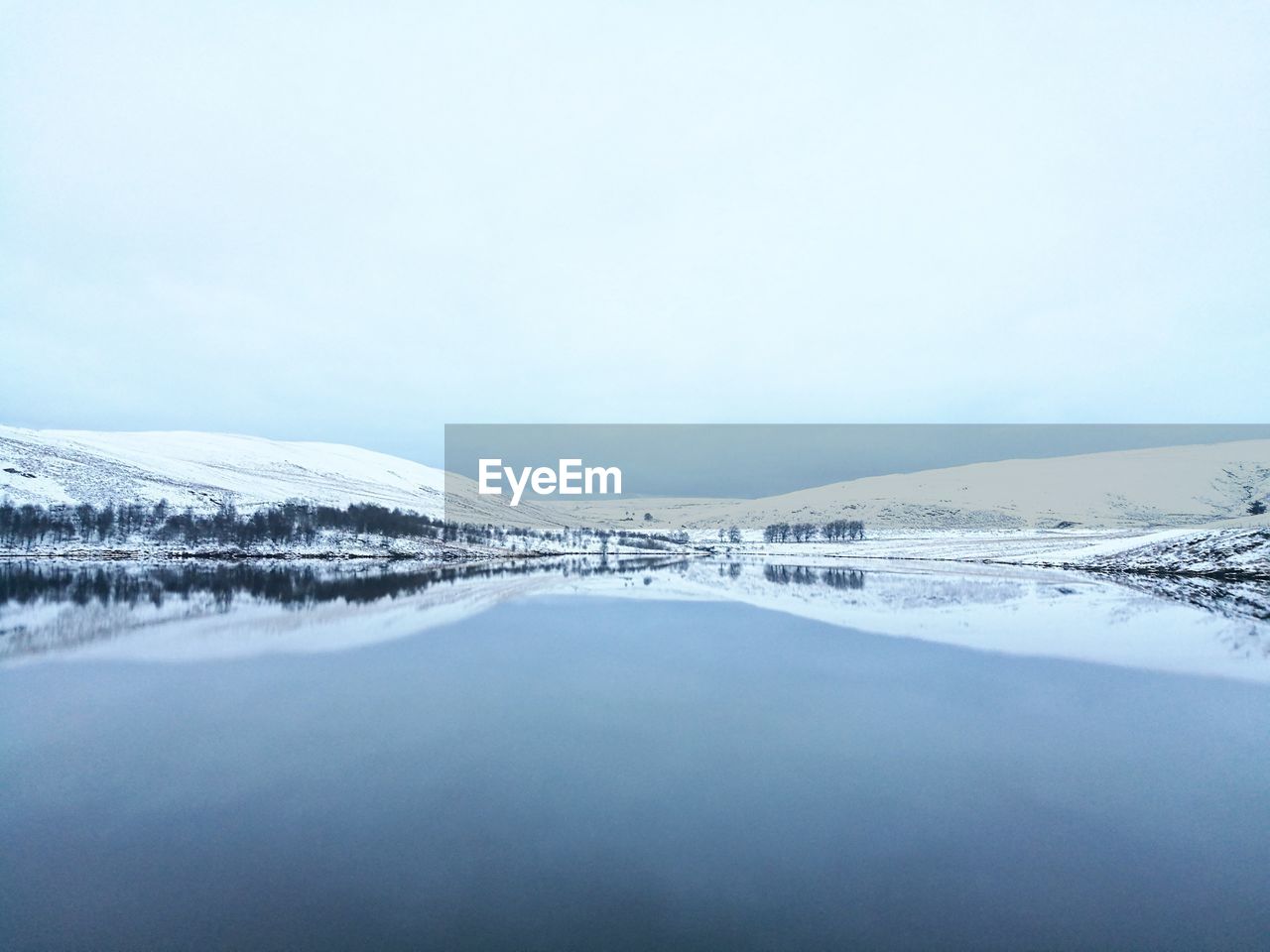 Scenic view of frozen lake against clear sky