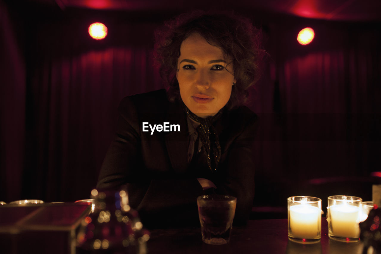 Woman sitting at a bar in a nightclub