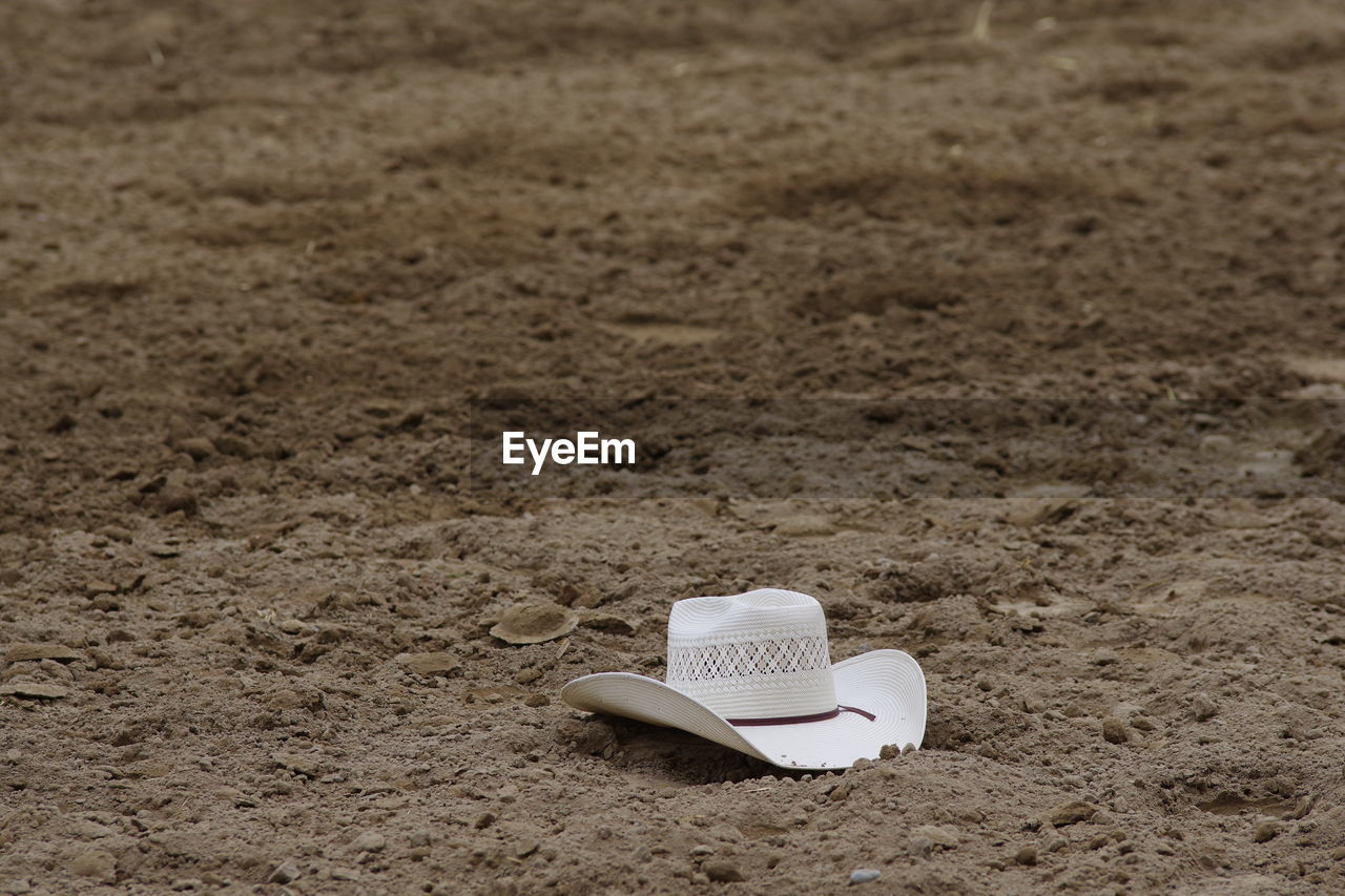 High angle view of hat in dirt arena
