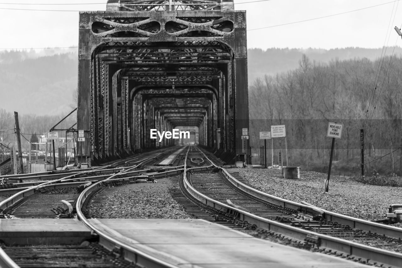 View of railroad tracks against bridge