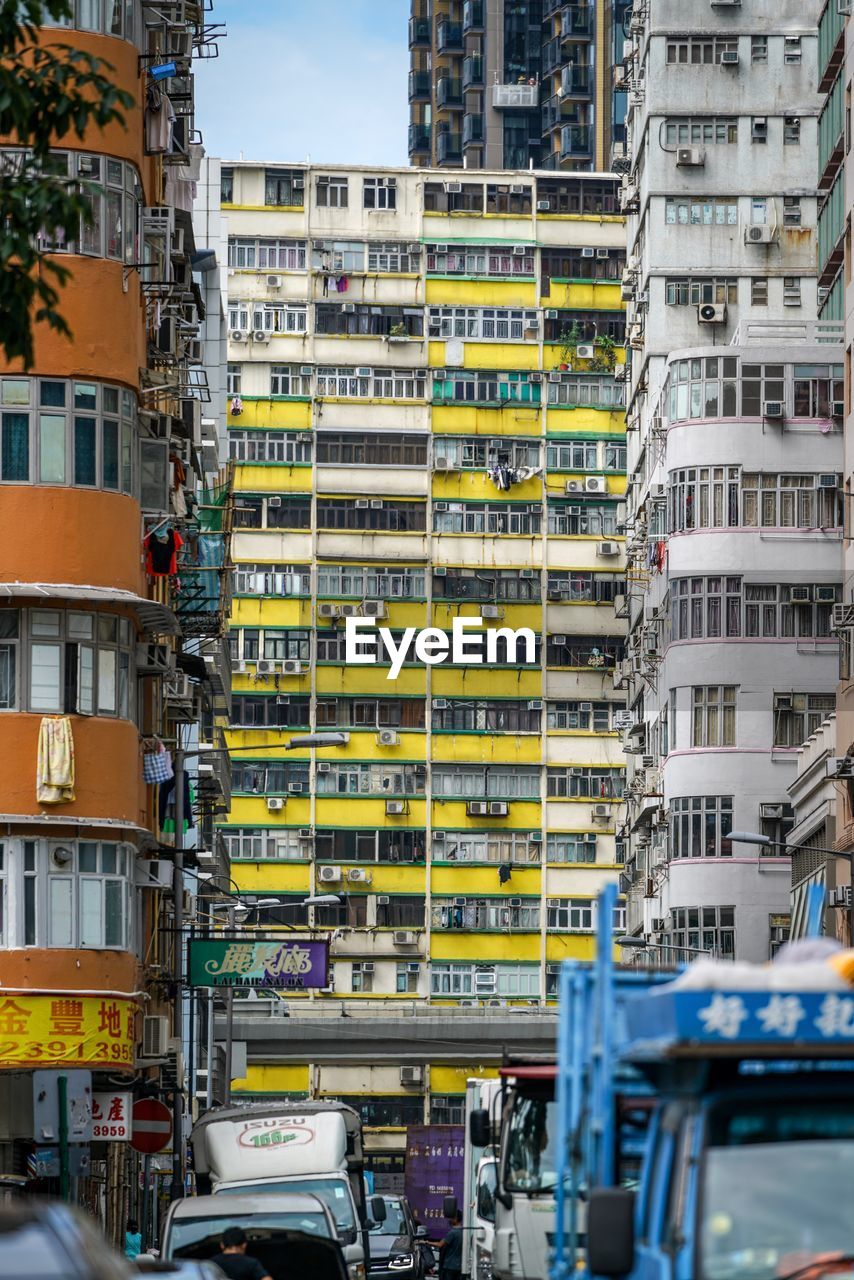 Vehicles on road by buildings in city