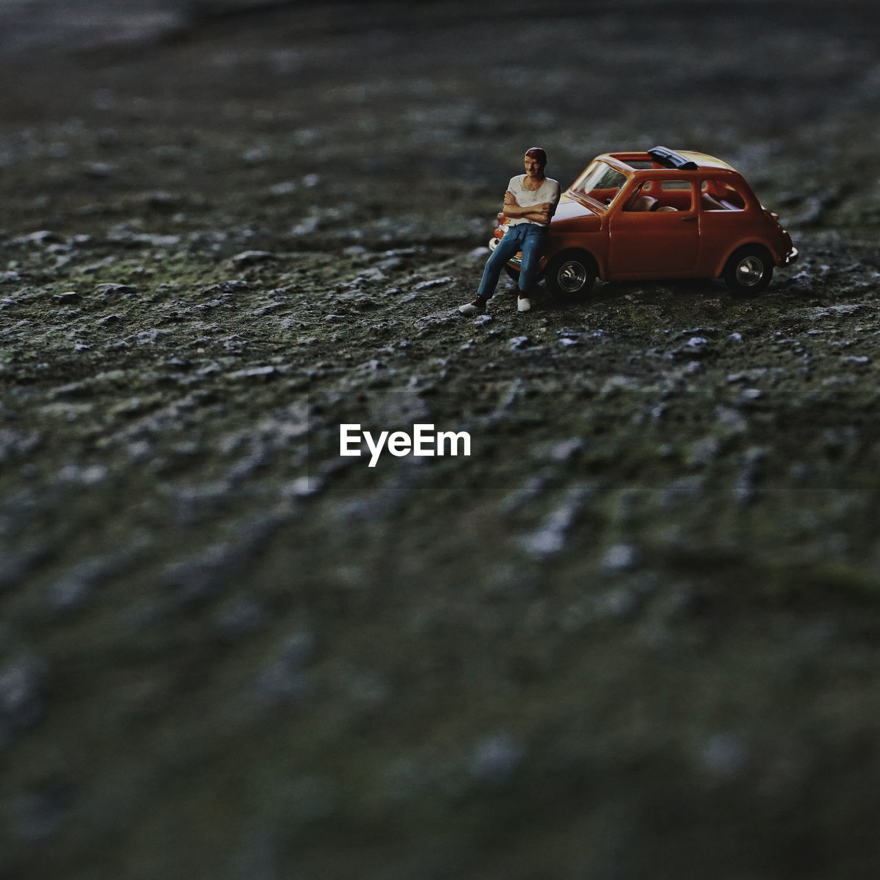 Close-up of toy car with figurine on floor