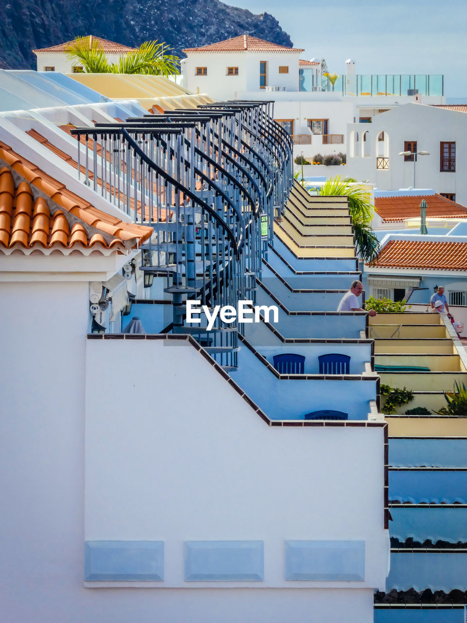 Side view of man at balcony against sky