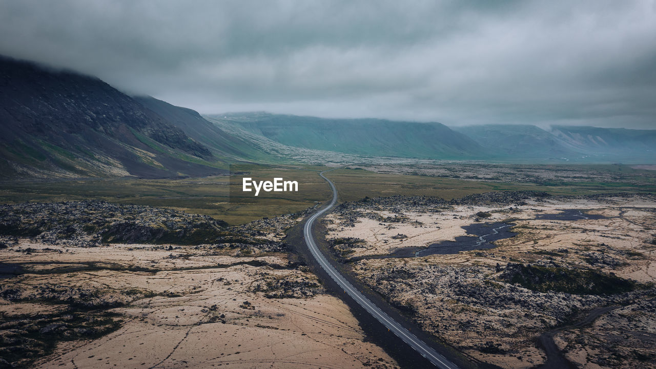 Aerial view of scenic driving road in iceland, moody atmosphere