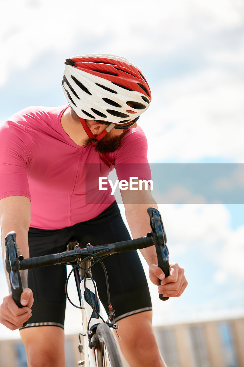 Man looking behind while sitting on bicycle