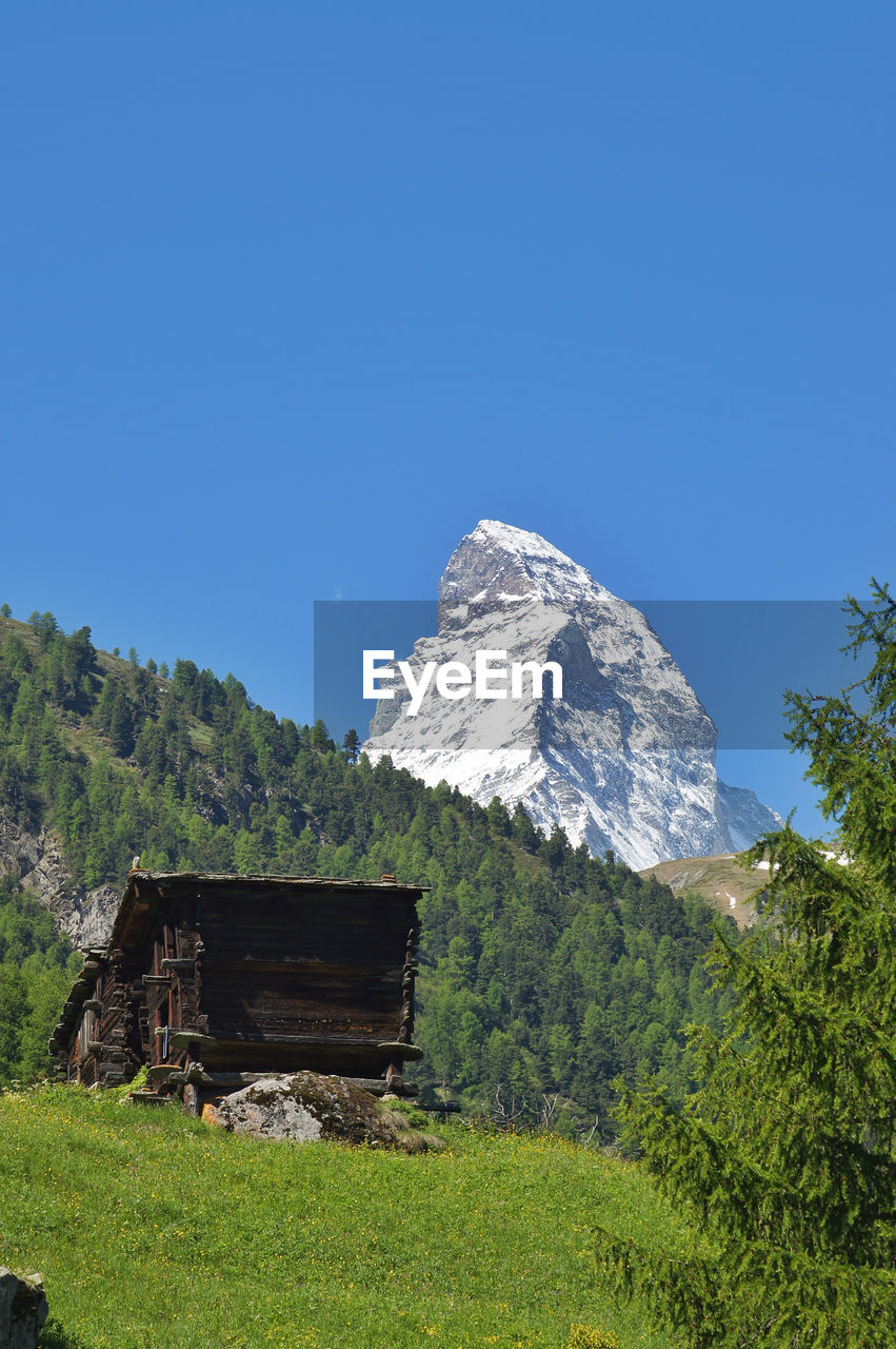 Low angle view of built structure against clear blue sky