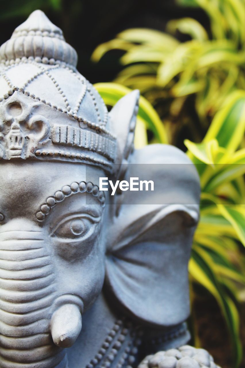 CLOSE-UP OF STATUE OF BUDDHA