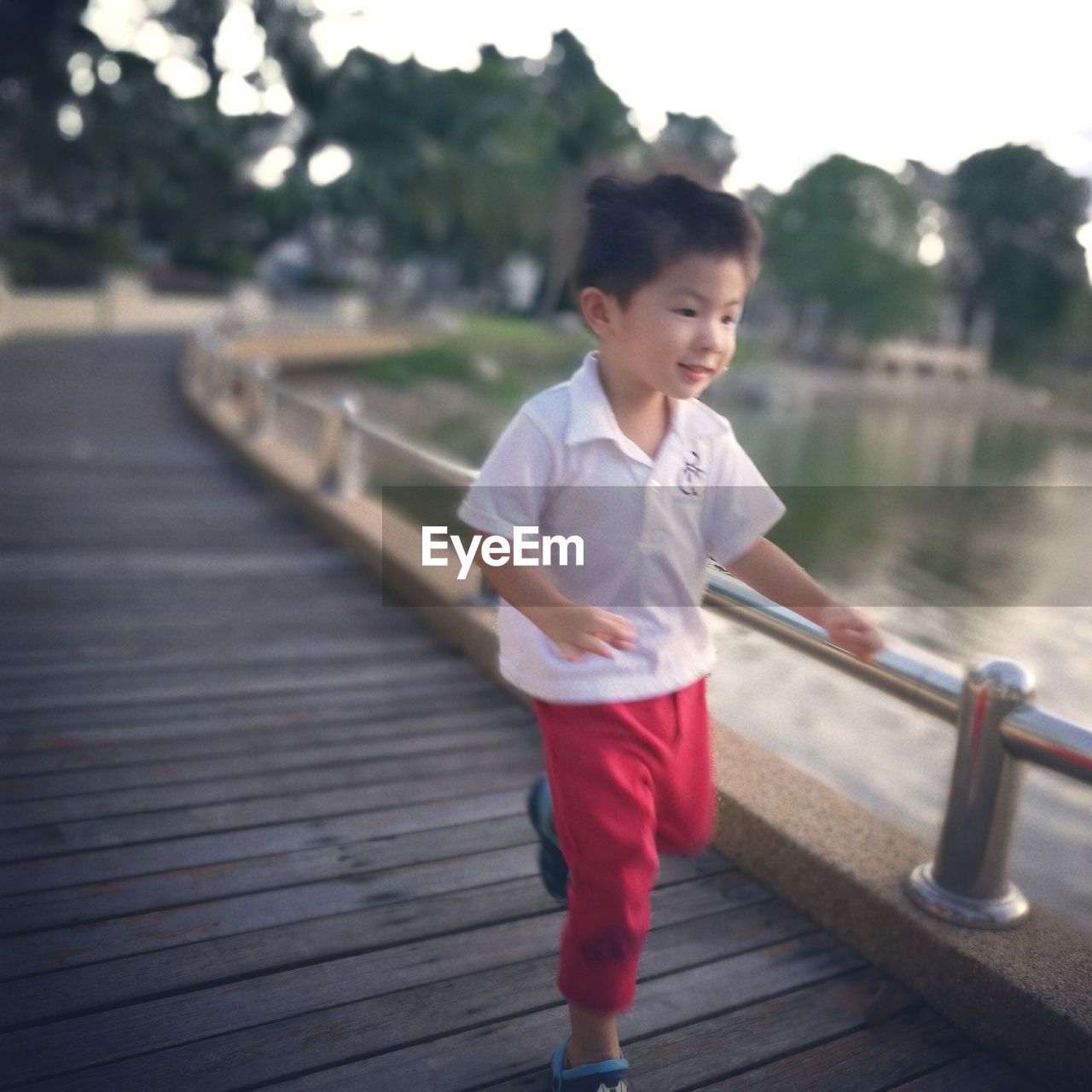 FULL LENGTH OF BOY STANDING ON WOODEN FLOOR