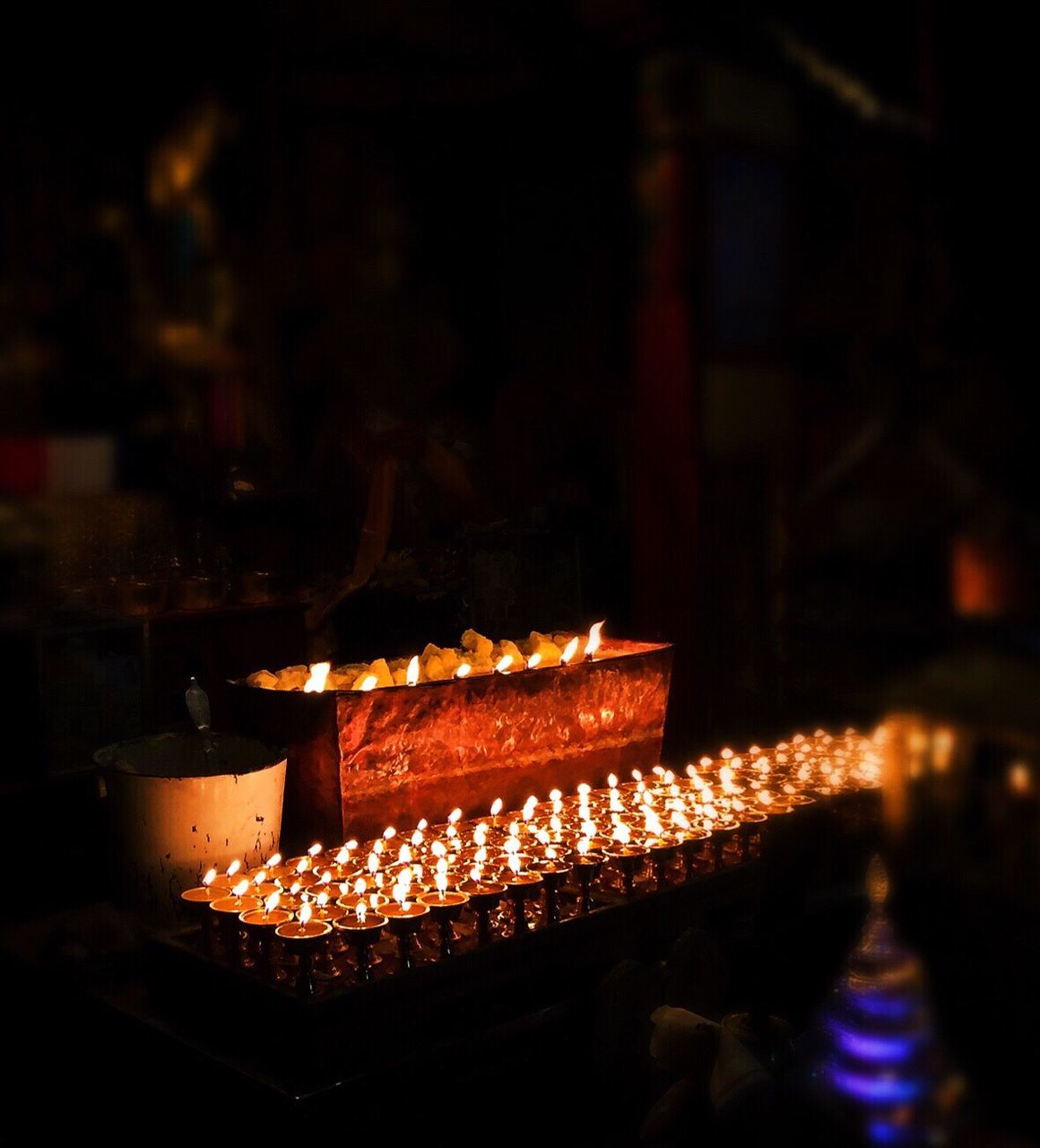 CLOSE-UP OF ILLUMINATED CANDLE