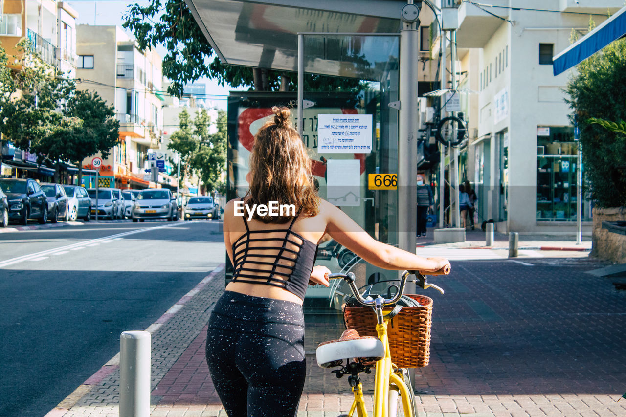 WOMAN RIDING BICYCLE ON STREET