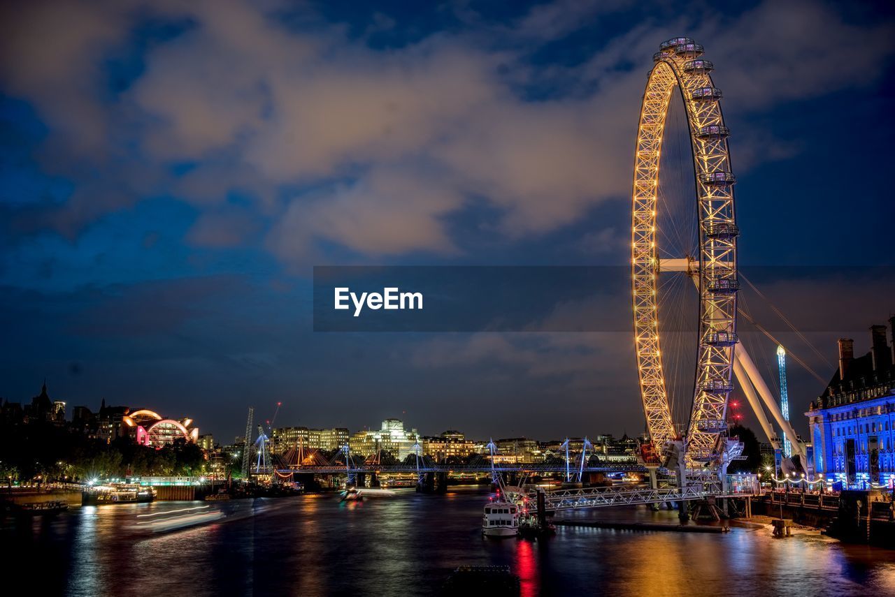 ILLUMINATED CITY AGAINST SKY AT NIGHT