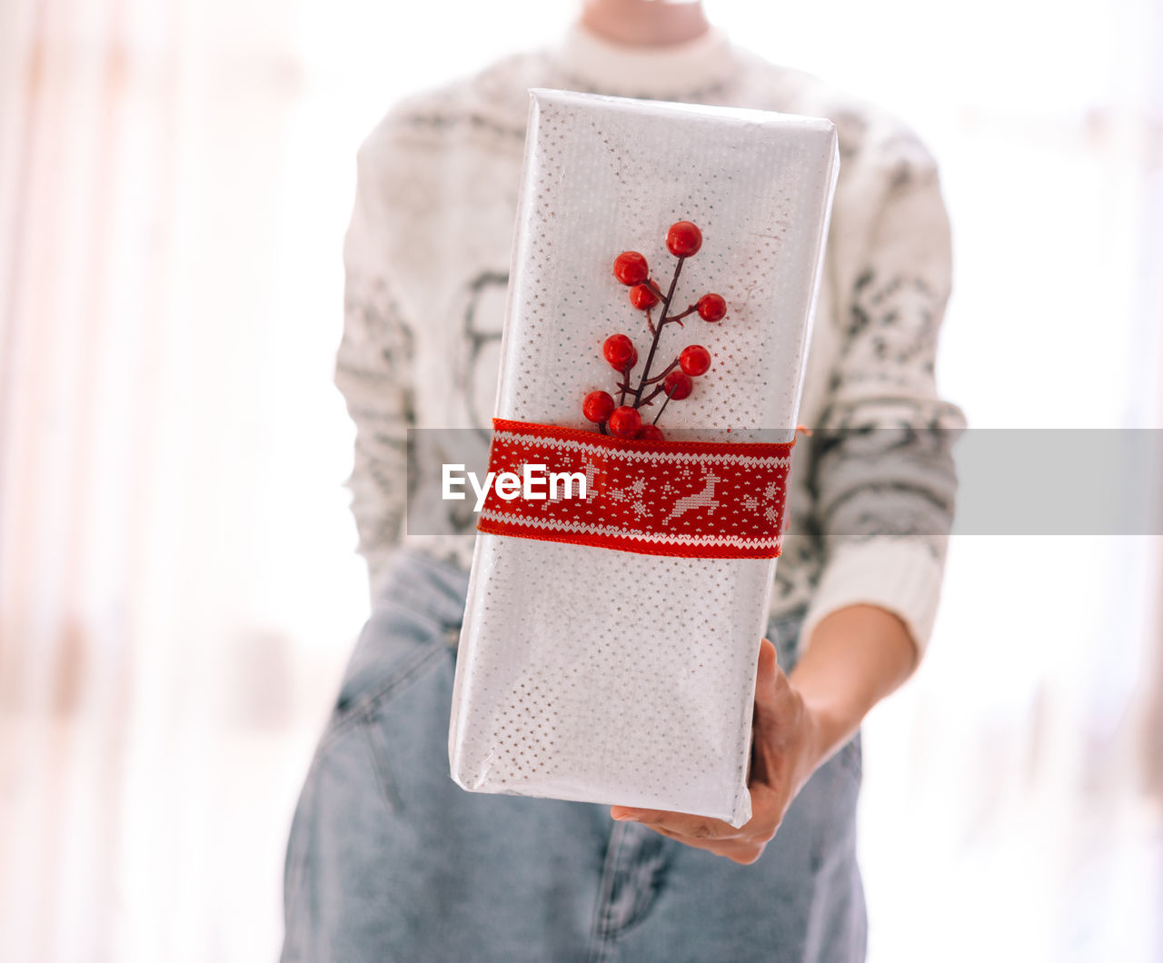 Midsection of woman holding christmas gift